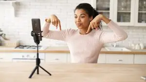 Woman recording herself doing a new content trend