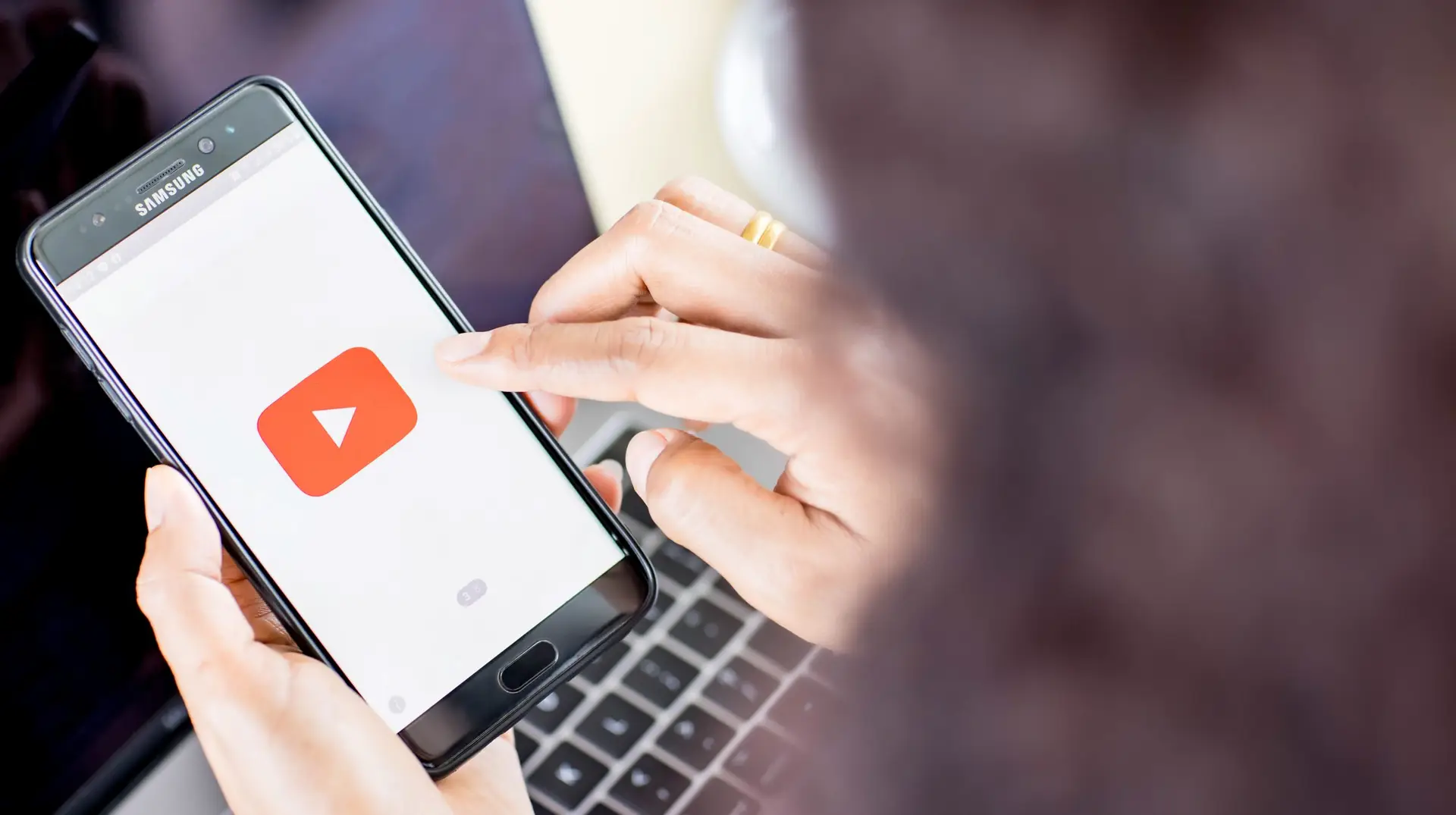 Woman holding a phone with youtube opened