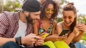 group of people laughing at a phone watching a content trend