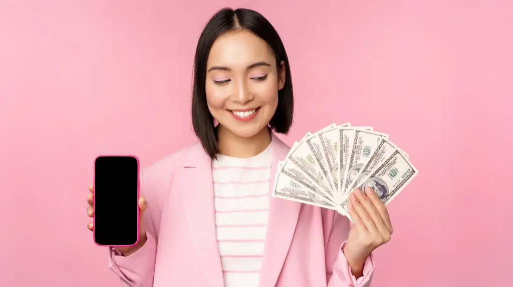 Woman holding up cash in her hand