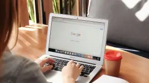 woman on a computer with google tab open