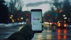 person holding phone with google it