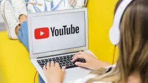 woman on a computer watching youtube about ai news