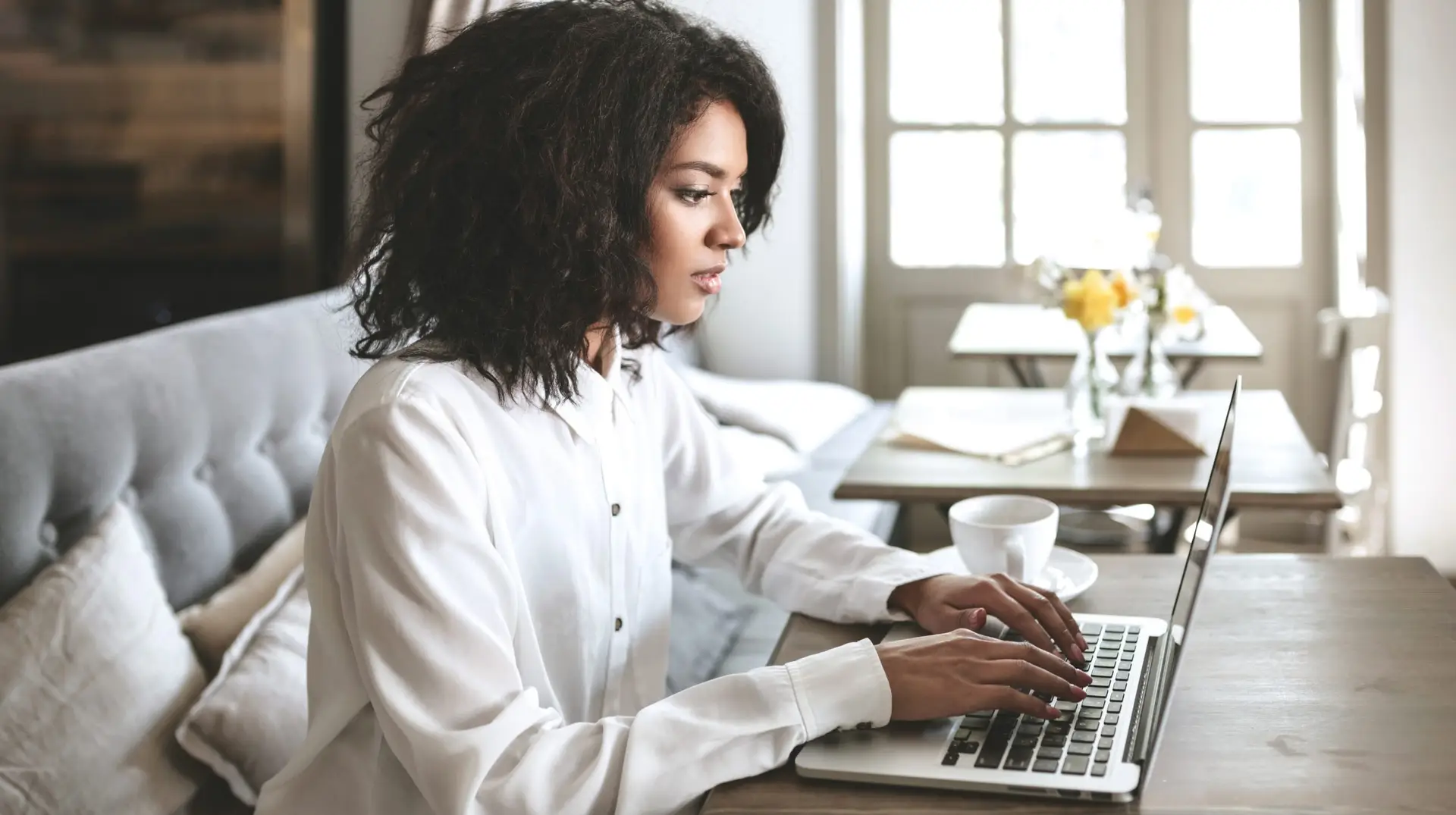 Woman working on a laptop trying to find ai news