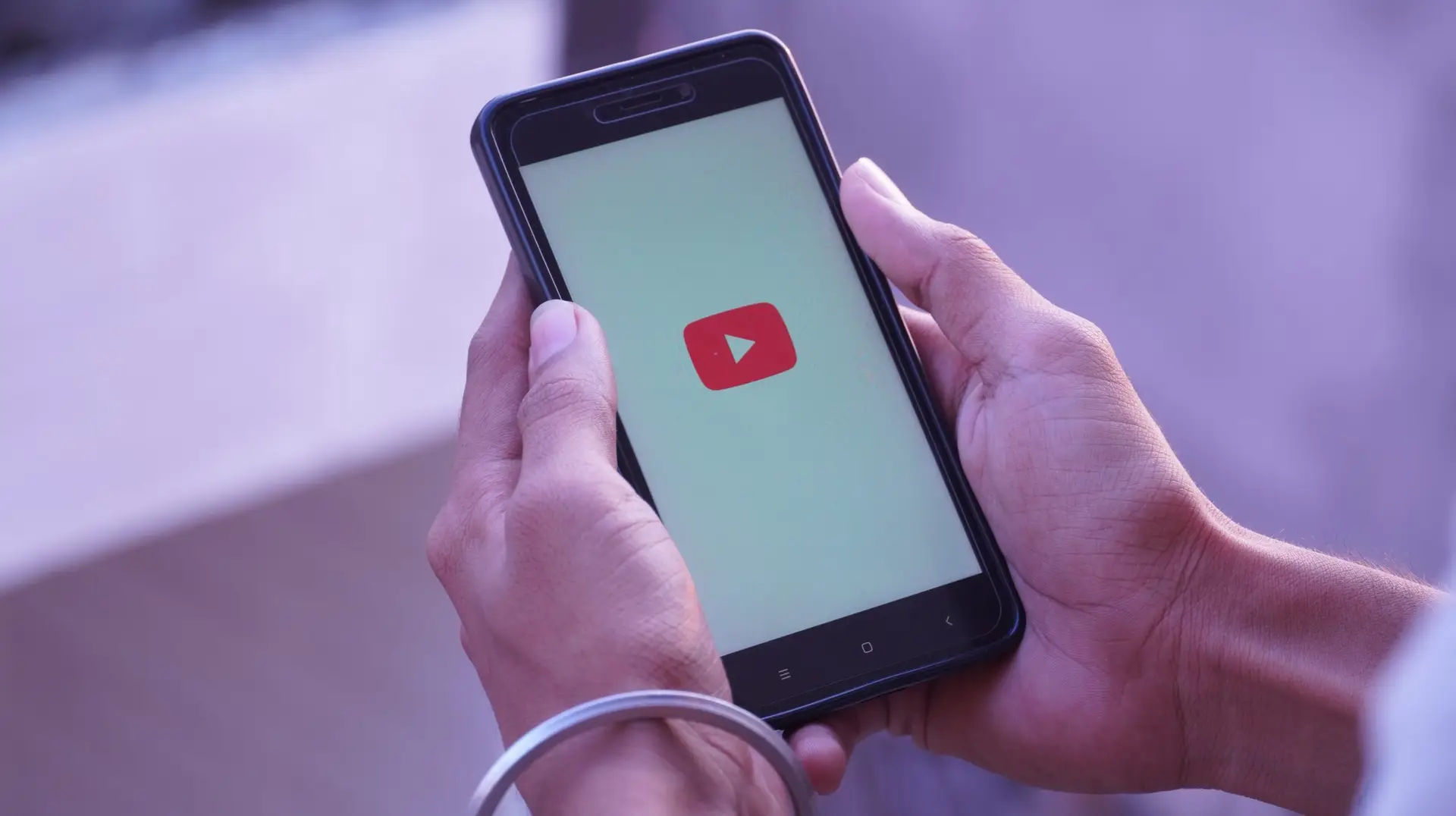 youtube splash screen logo in in mobile and mobile in hand