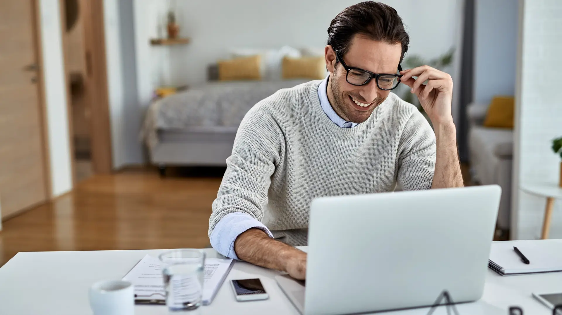 Happy freelance worker using computer while working at home.