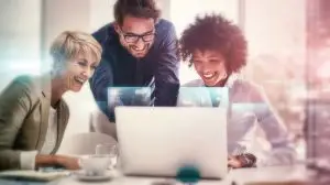 Hologram, computer and teamwork by business people with networking for futuristic company growth and connection. Technology, software and team working on 3D digital worldwide development information