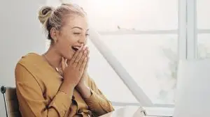 Remote work from home, surprise and woman with laptop, online reading and email notification. Person, creative and employee with computer, shocked and expression with announcement, prize and reaction