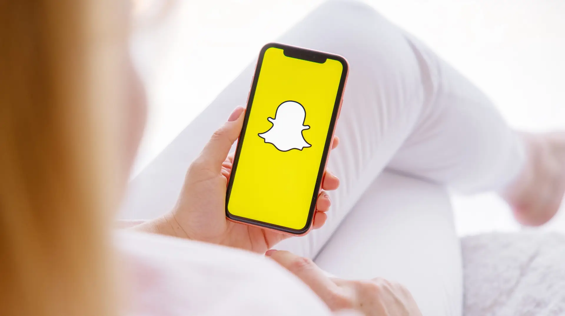 Riga,,Latvia,-,March,26,,2021:,Woman,Holding,Phone,With