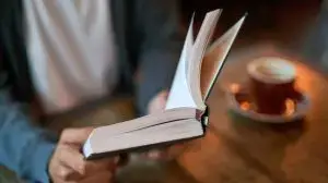Hands,,Person,And,Book,With,Coffee,At,Cafe,In,Table