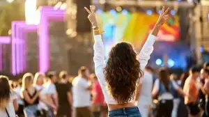 Back,View,Of,Young,Woman,At,Summer,Beach,Music,Festival.