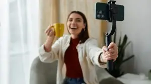 A,Young,Woman,,Dressed,Casually,,Vlogs,While,Holding,A,Smartphone