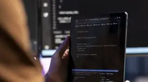 Teleworking programmer designing and developing software using tablet