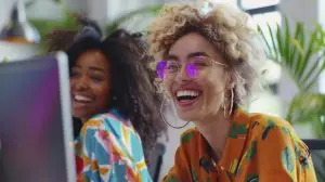 two females laughing at a computer