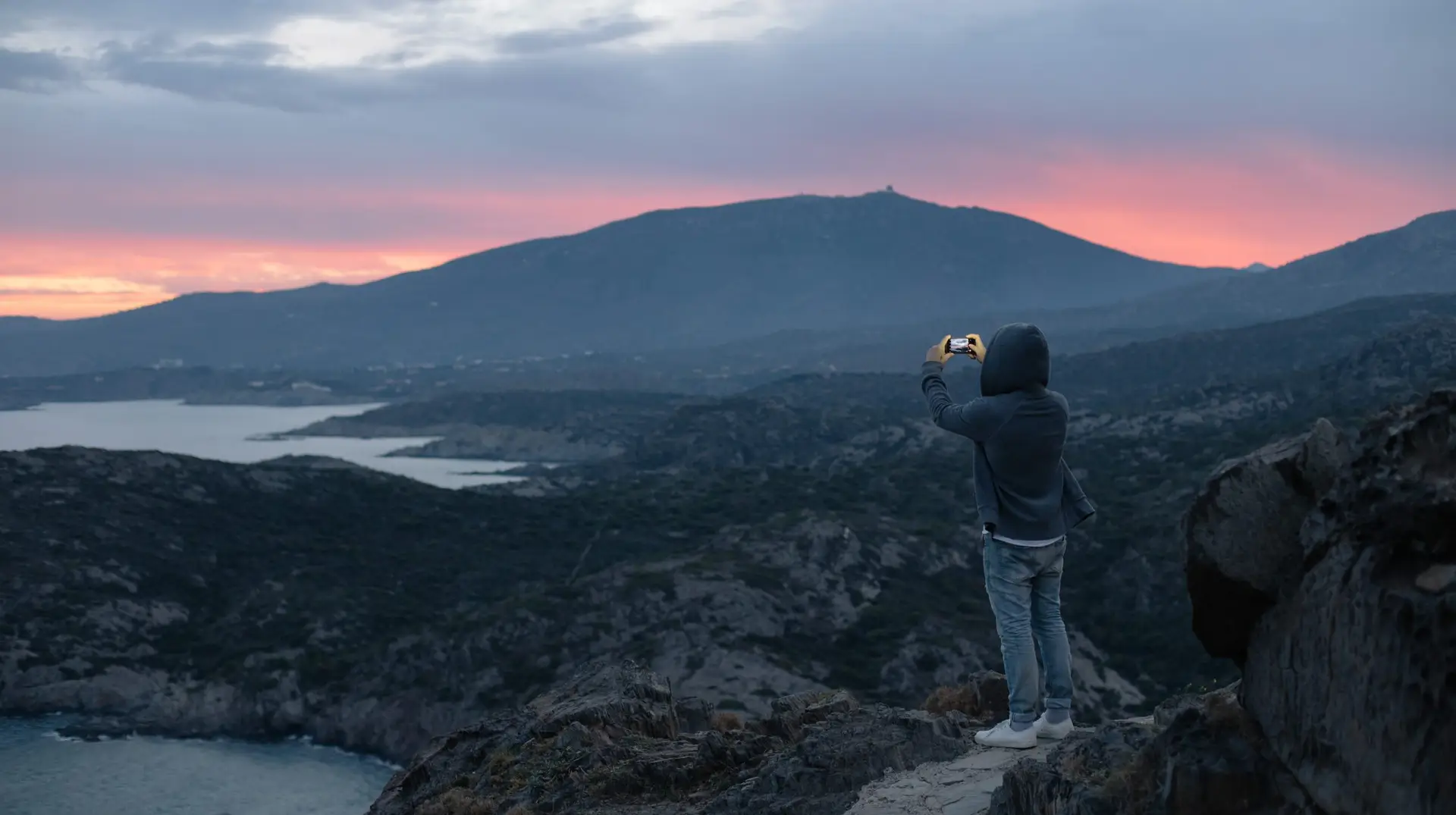 man makes photo of epic landscape sunset