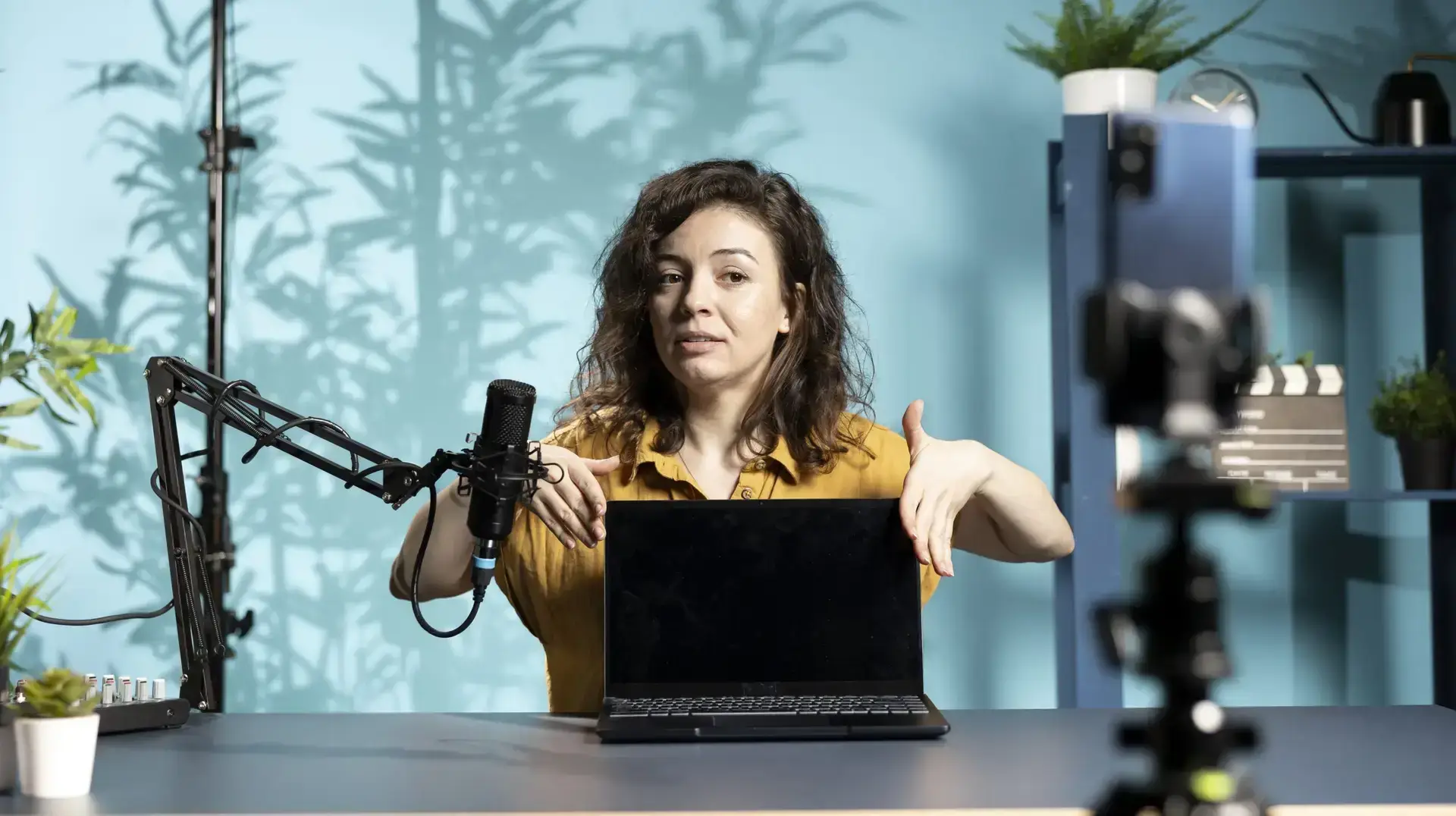 Woman in studio endorsing laptop from brand sponsoring video