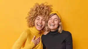 An image of two women laughing, implying that they saw a funny meme