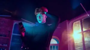 Cinematic portrait of handsome young man in neon lighted interior