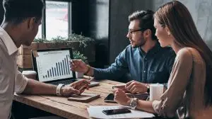 Business,Professionals.,Group,Of,Young,Confident,Business,People,Analyzing,Data