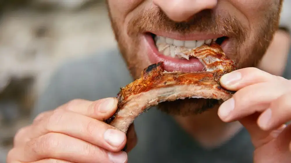 People,Eat,Food.,Man,Eating,Barbecue,Ribs,In,Grill,Bar