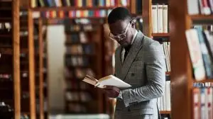 Smart,Looking,African,American,Businessman,In,Glasses,Standing,And,Reading