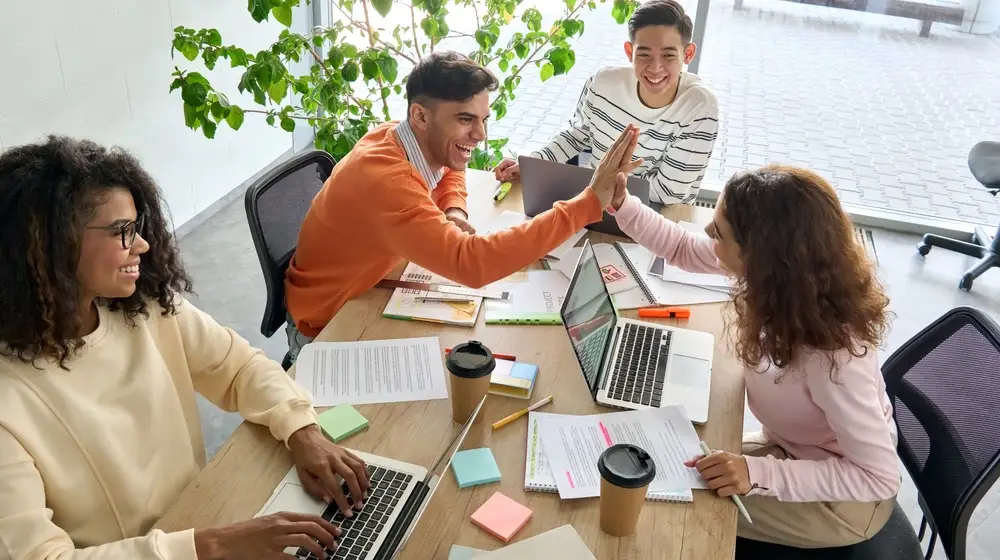 Young,Happy,Laughing,Creative,Team,Four,Multicultural,Coworkers,Or,College