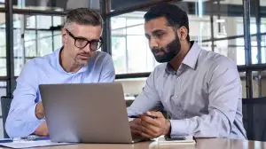 Two,Diverse,Business,Men,Analysts,Partners,Talking,,Working,Together,,Discussing