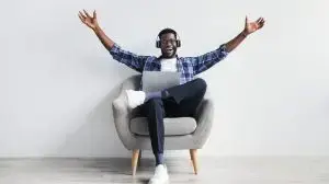 Excited,Millennial,African,American,Guy,In,Headphones,Gesticulating,,Greeting,Someone