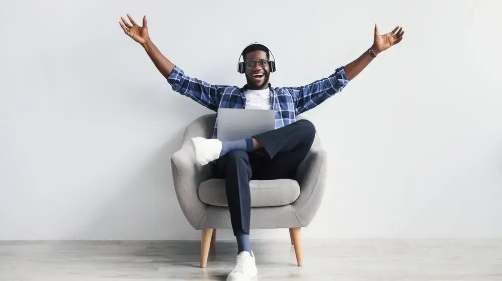 Excited,Millennial,African,American,Guy,In,Headphones,Gesticulating,,Greeting,Someone