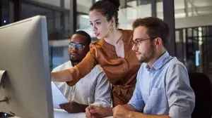 Learning,,Computer,And,Training,Business,Interns,In,Night,Office,With