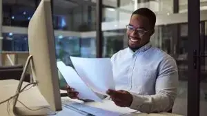 Documents,,Night,And,Computer,With,A,Businessman,Working,At,His
