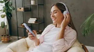 Young,Woman,Wear,Casual,Clothes,Sits,In,Armchair,Listen,To