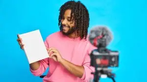 A,Man,Shows,A,Blank,Book,While,Recording,Himself,In