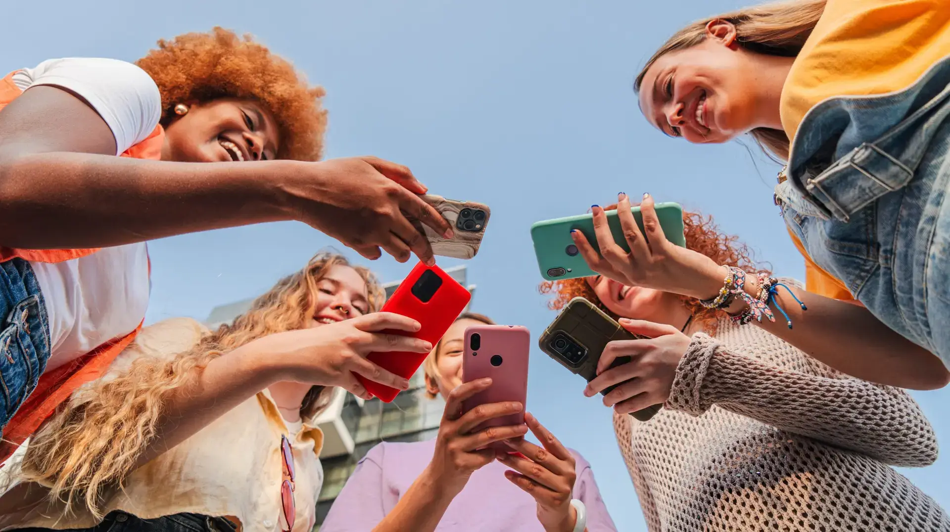 Low,Angle,View,Of,A,Group,Of,Smiling,Multiracial,Teenage