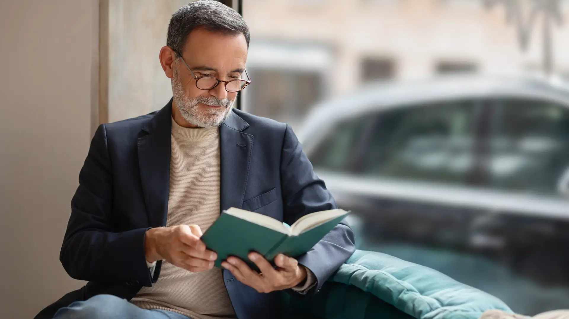 Thoughtful,Smart,Caucasian,Senior,Man,With,Glasses,Engrossed,In,Reading