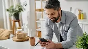 A,Bearded,Man,In,A,Casual,Shirt,Works,Remotely,From
