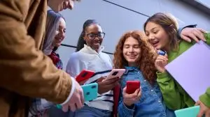 Low,Angle,Of,Group,Generation,Z,Friends,Smiling,At,Their