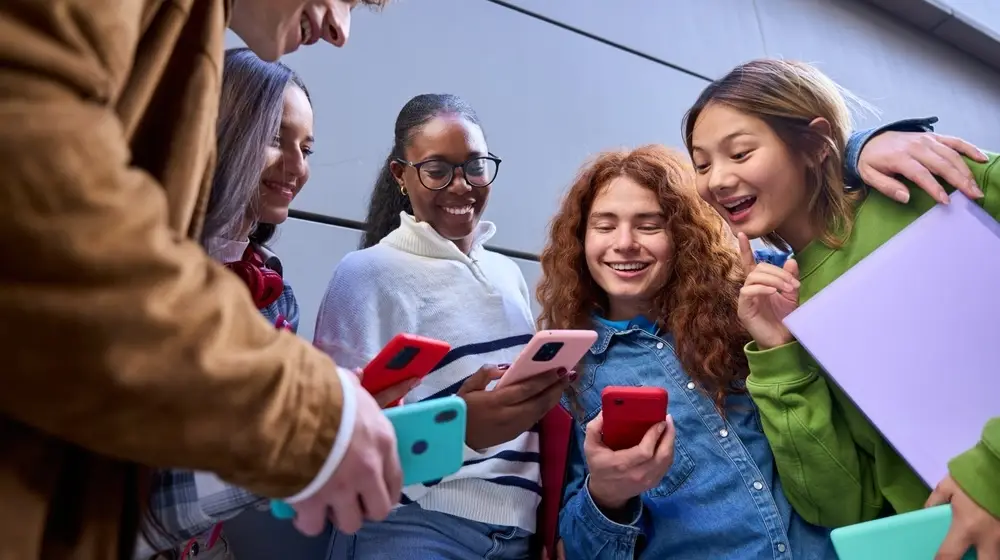 Low,Angle,Of,Group,Generation,Z,Friends,Smiling,At,Their