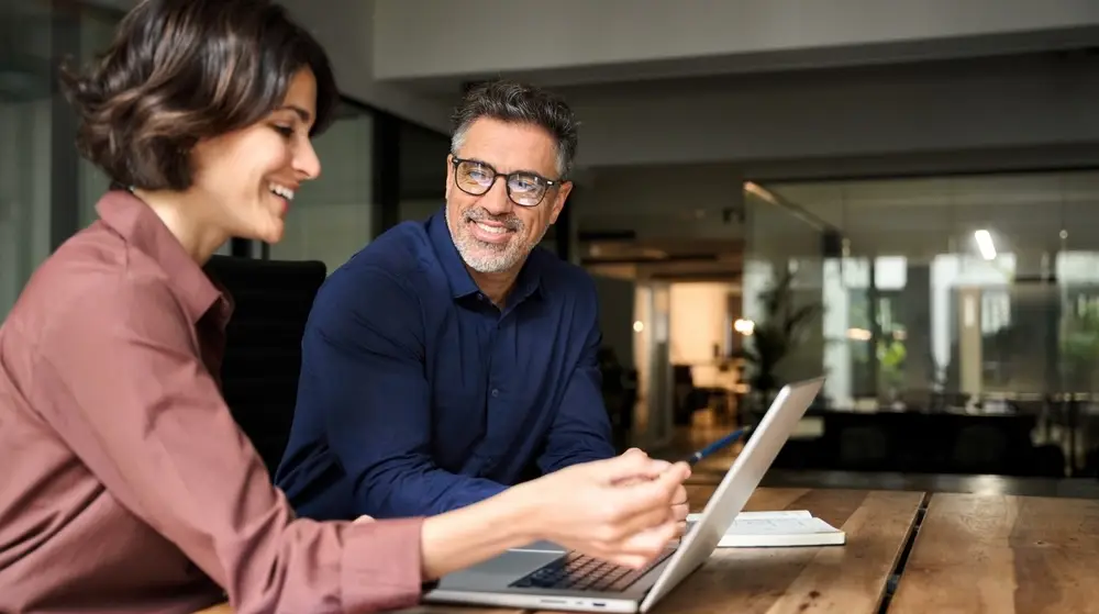 Business,Team,Two,Happy,Busy,Executives,Working,Together,Using,Laptop