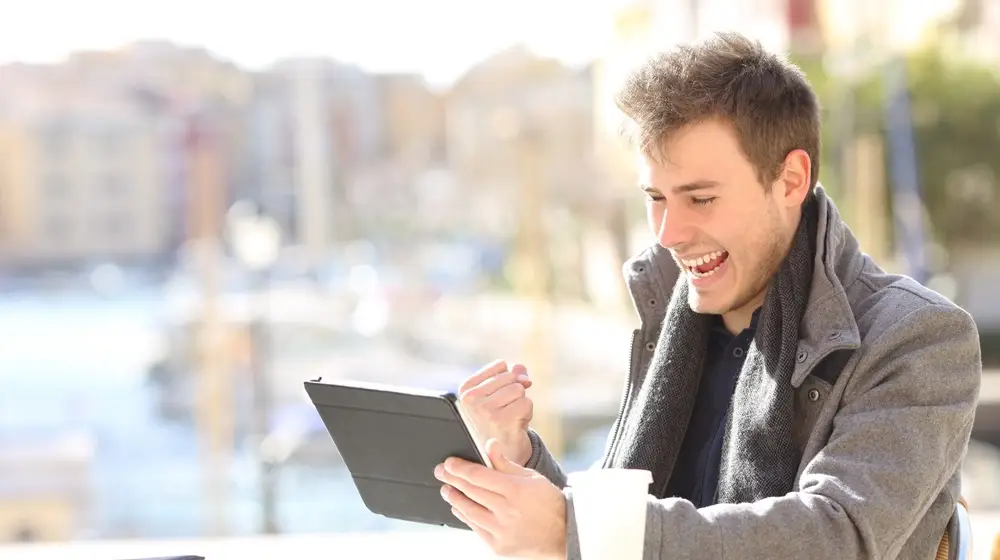 Handsome,Euphoric,Winner,Winning,And,Watching,A,Tablet,In,A