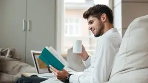 Joyful,Businessman,Dressed,In,White,Shirt,Sitting,In,Cafe,And