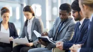 Multi-ethnic,Group,Of,Business,People,Sitting,In,Row,In,Modern