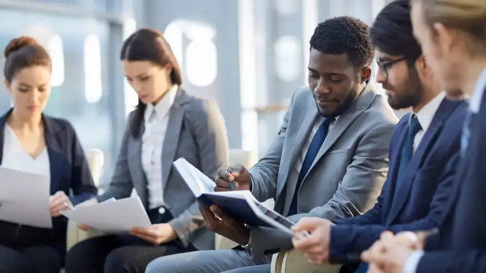 Multi-ethnic,Group,Of,Business,People,Sitting,In,Row,In,Modern