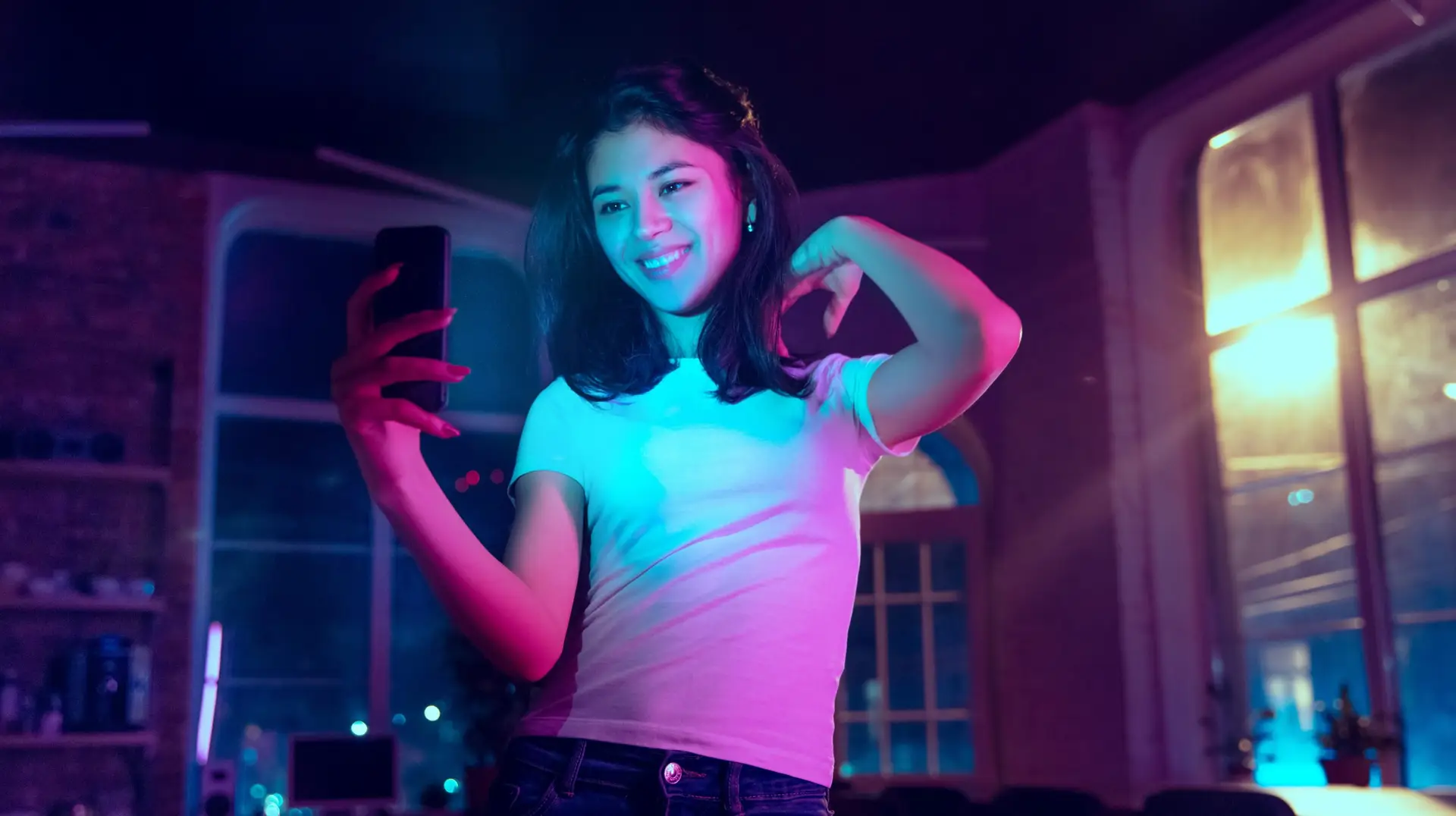Cinematic portrait of handsome young woman in neon lighted interior