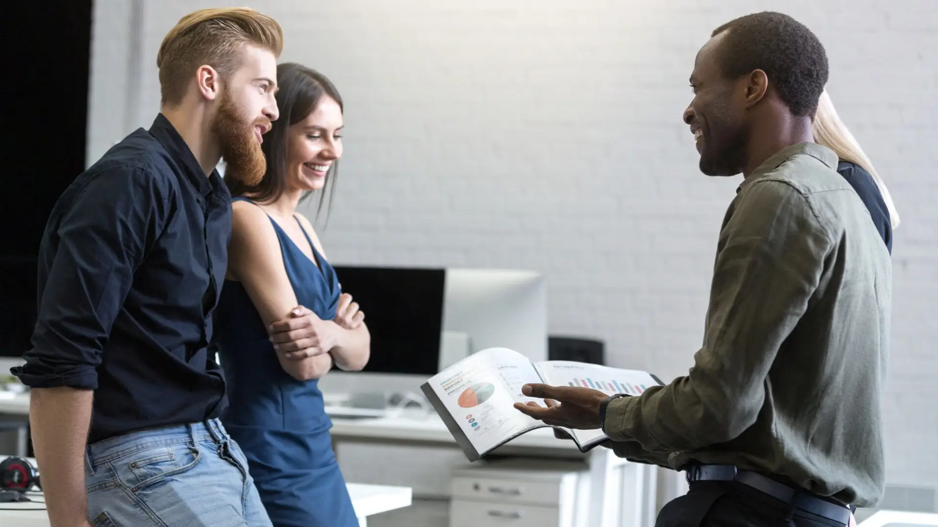 Employees are communicating with each other in the office.
