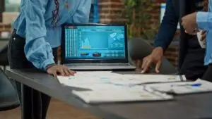 In the image, executives in the business meeting are looking at company data, representing the need to build your markets with intentions.