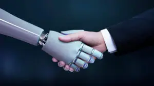 In this picture, a businessman is shaking hands with a robot, representing partnership.