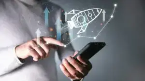 Entrepreneur launching a digital rocket ship from a smartphone to represent business scaling