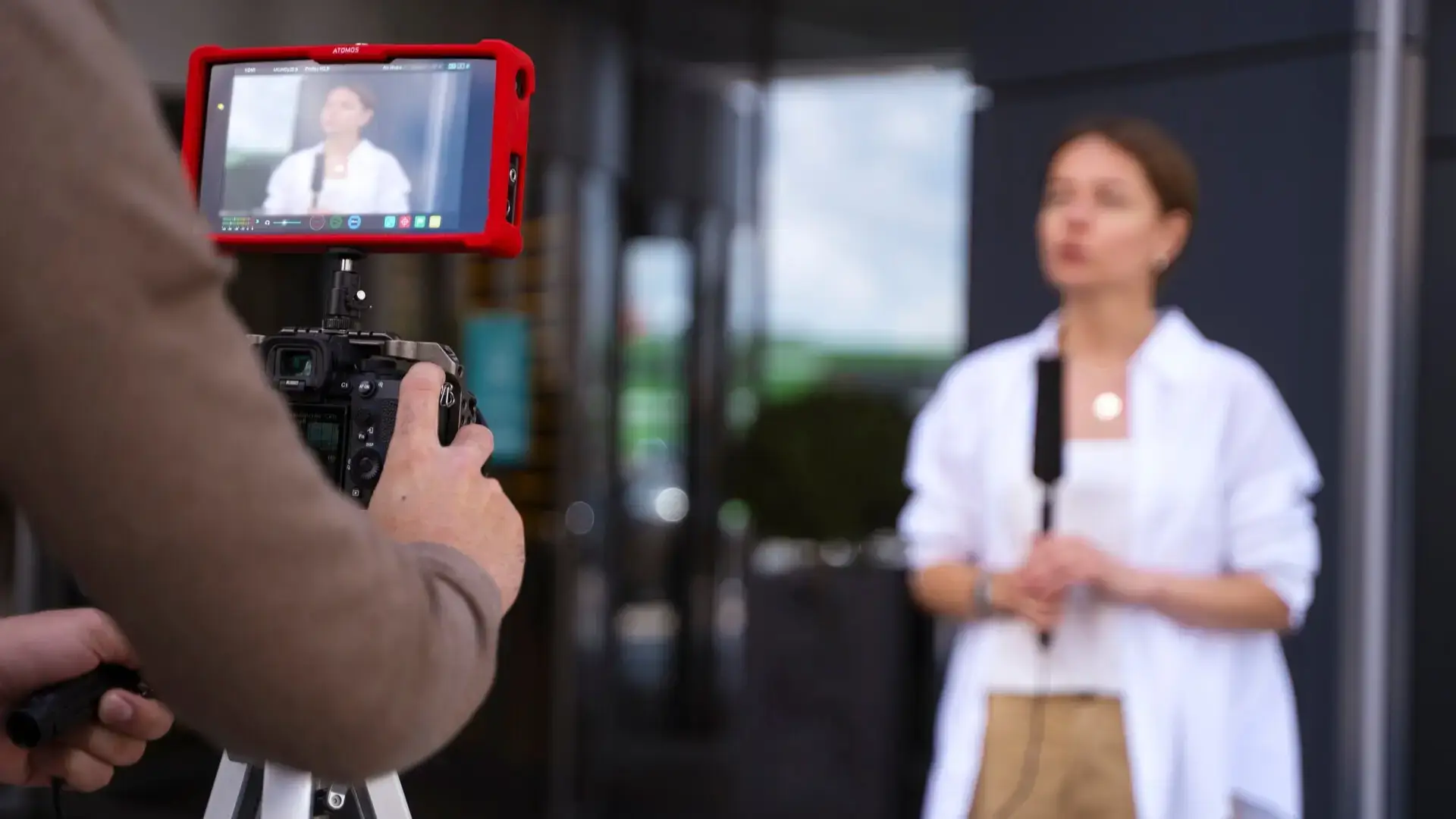 An entrepreneur is recording a video to post on YouTube to help draw customers to her business.