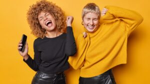 2 woman laughing at a social media trend